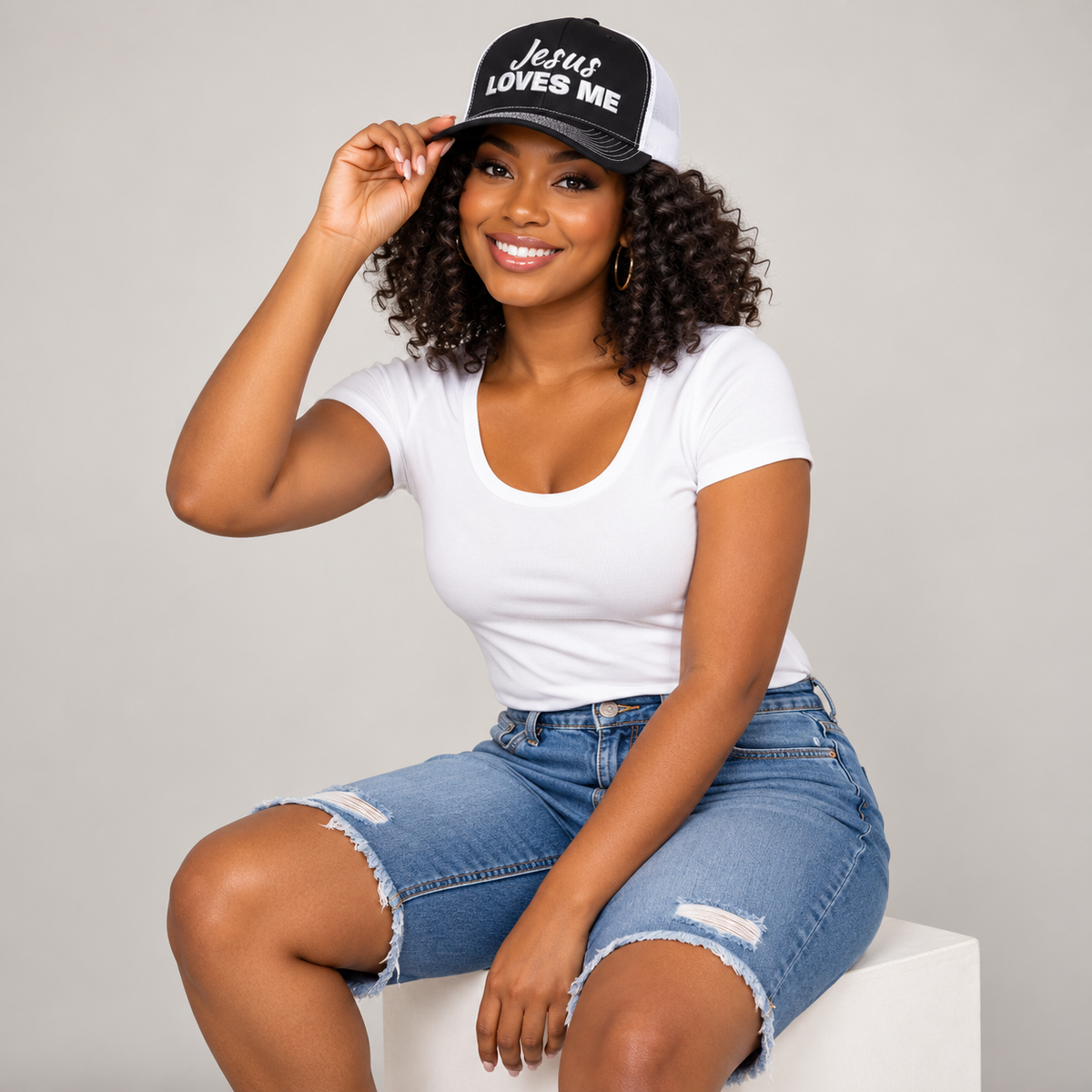Solo smiling model wearing Jesus Loves Me Christian Snapback Trucker Cap, Black / White
