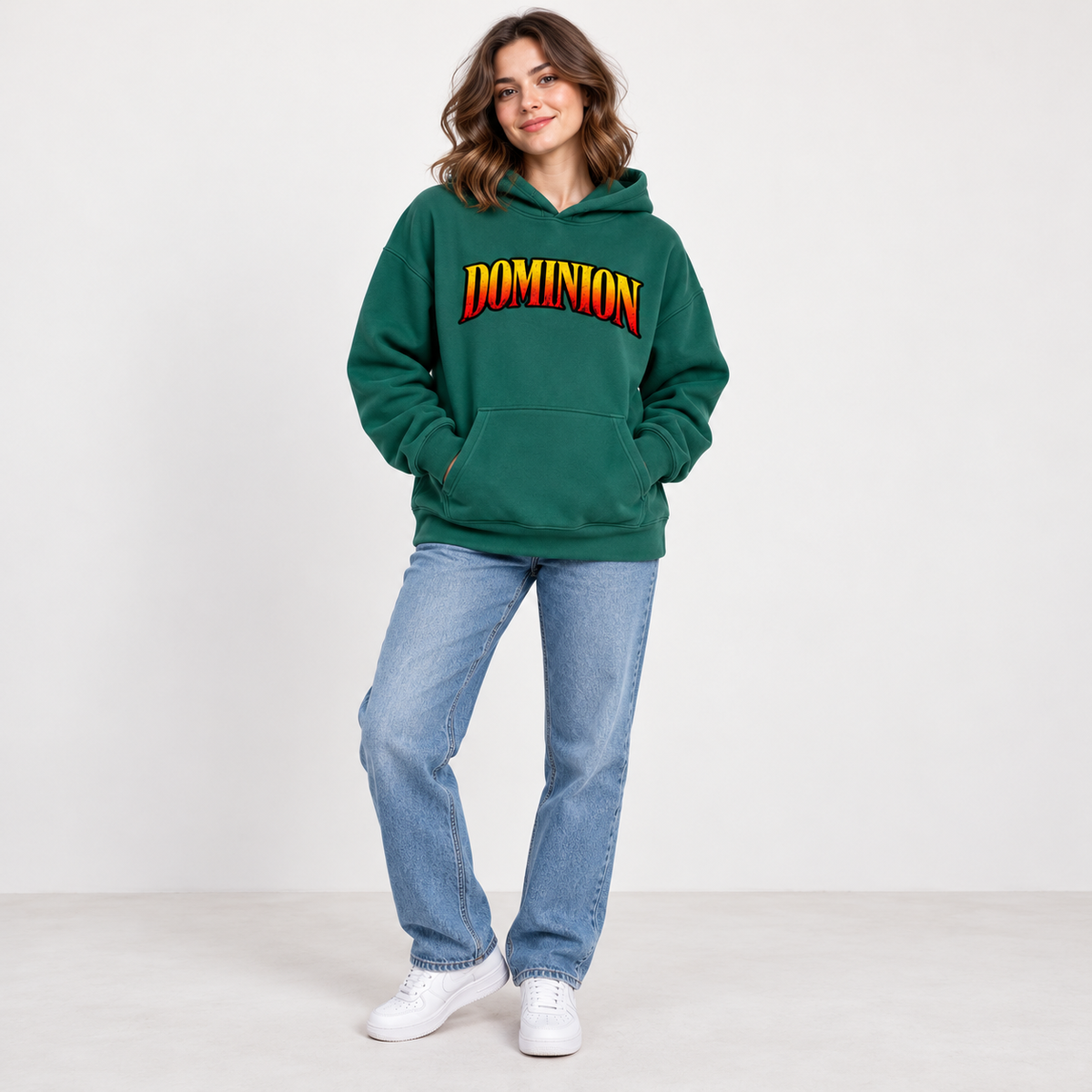 Solo smiling model wearing Dominion hoodie, Eden Green