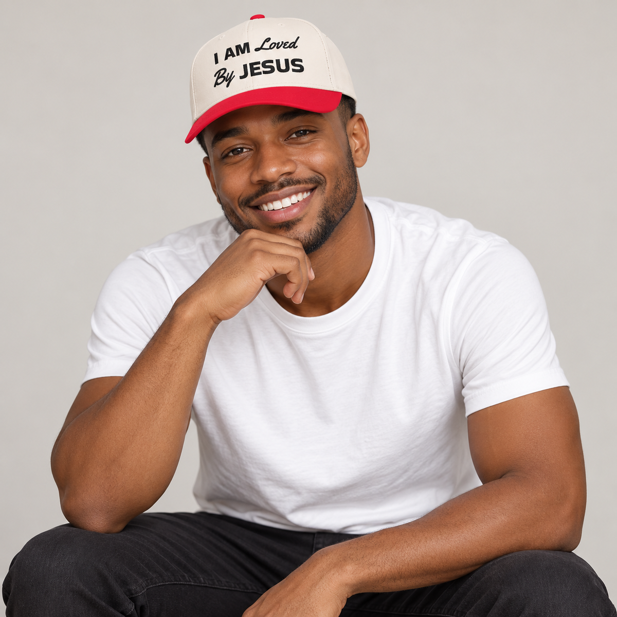 Solo smiling model wearing I am Loved By Jesus - Cap, White