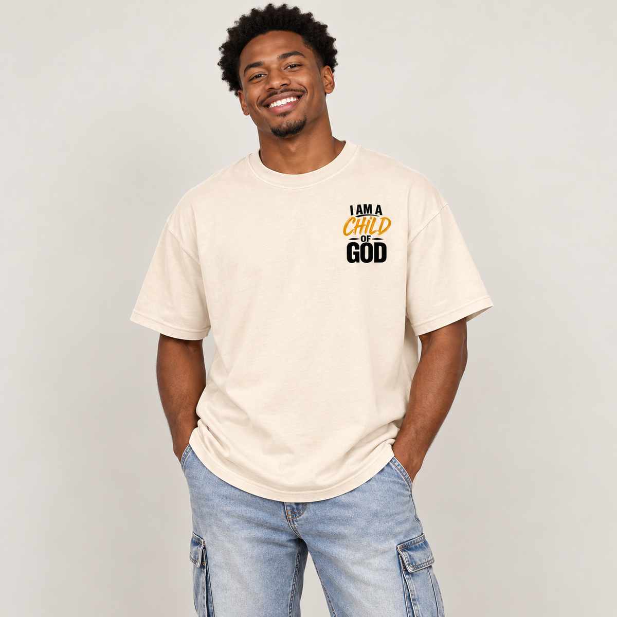Solo smiling model wearing Child of God tee, Light Apricot