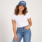 Solo smiling model wearing Redeemed by the Blood - Embroidered Cap, Blue