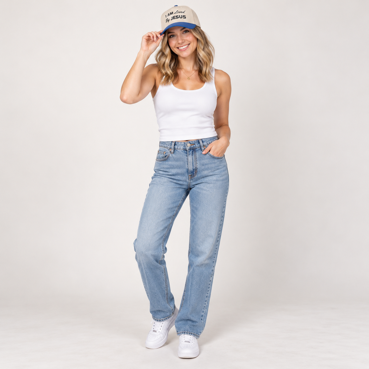 Solo smiling model wearing I am Loved By Jesus - Cap, Royal / Natural