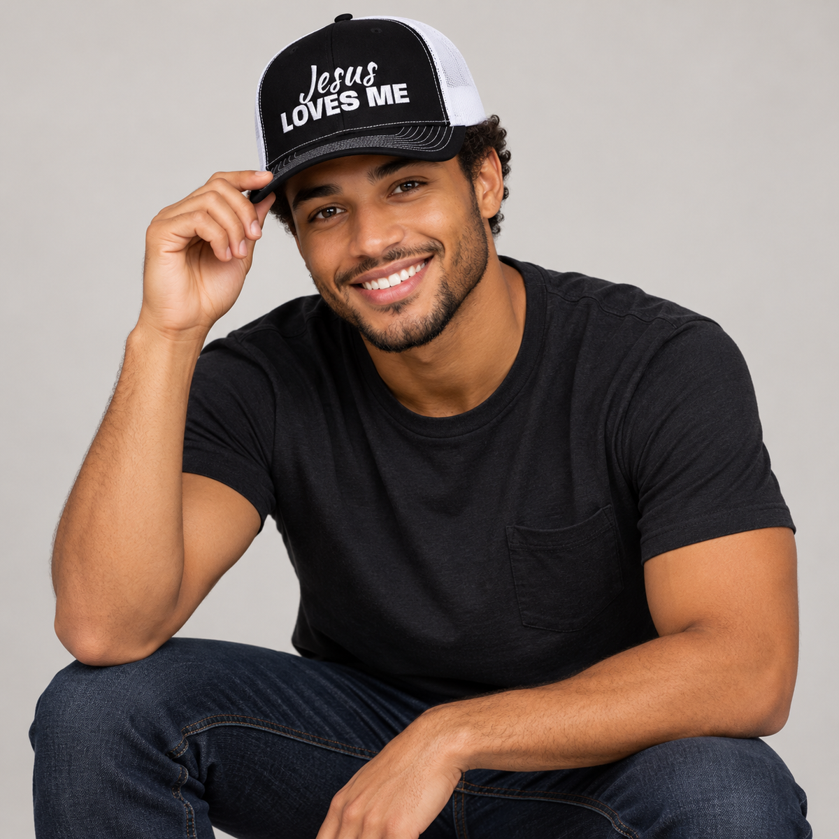 Solo smiling model wearing Jesus Loves Me Christian Snapback Trucker Cap, Black
