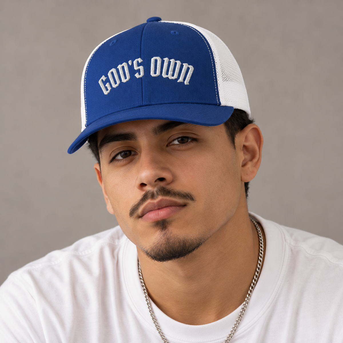 Model mockup of God's Own trucker cap in Royal / White
