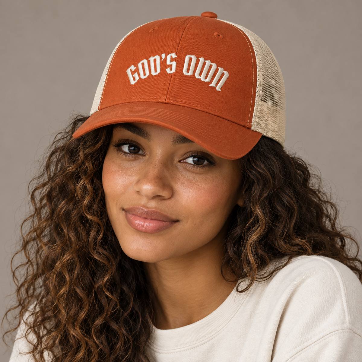 Model mockup of God's Own trucker cap in Rustic Orange / Khaki