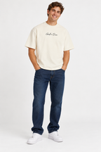 White God's Own Boxy Oversized Tee worn by smiling young male model in jeans