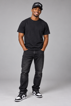 Smiling male model wearing the Black God’s Own trucker cap