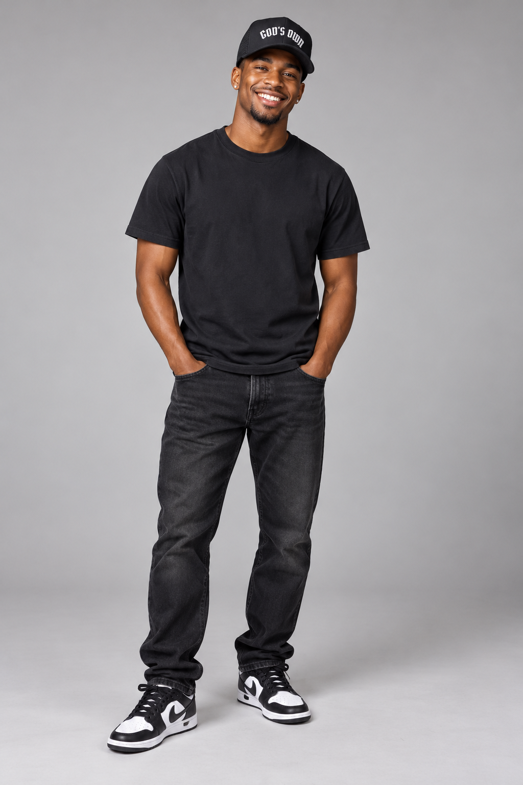 Smiling male model wearing the Black God’s Own trucker cap