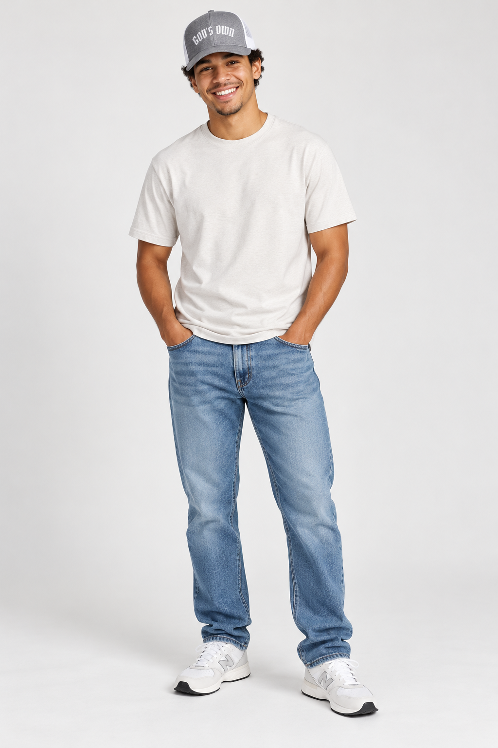Smiling male model wearing the Heather Grey and White God’s Own trucker cap