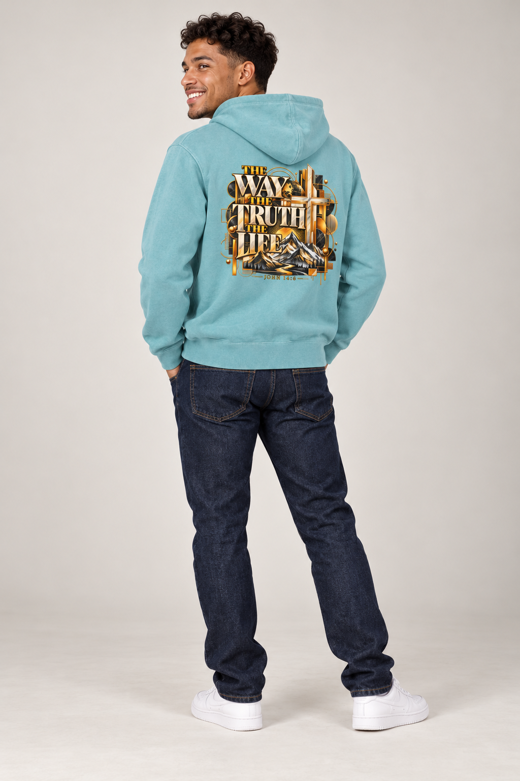 Smiling male model wearing Pigment Light Blue Jesus hoodie, back artwork visible
