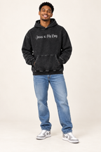 Black Beauty Jesus is My King Snow Washed Loose Cotton Hoodie worn by smiling young male model in jeans