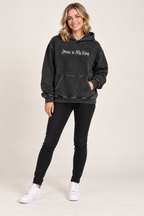 Dark Gray Jesus is My King Snow Washed Loose Cotton Hoodie worn by smiling young female model in jeans