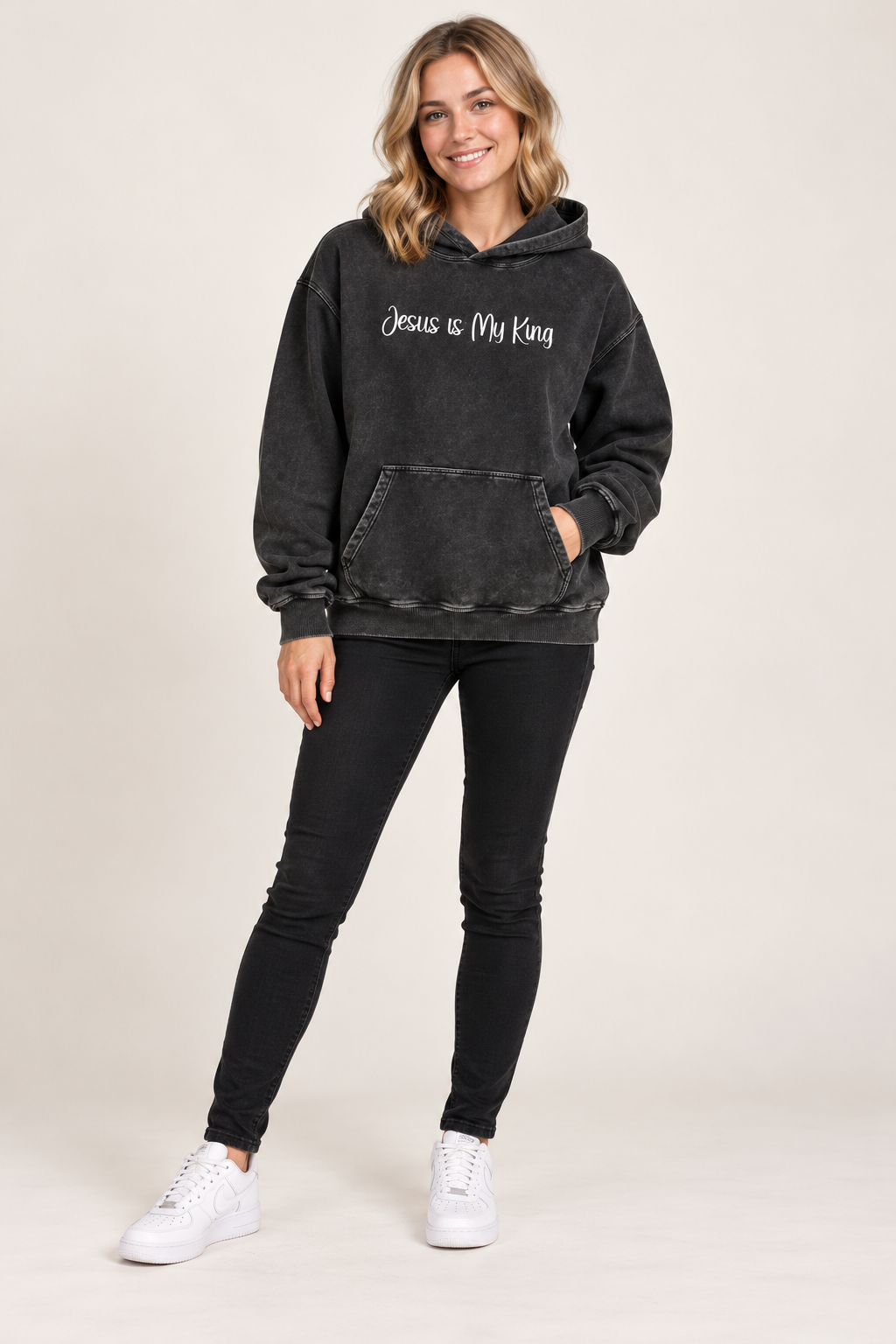 Dark Gray Jesus is My King Snow Washed Loose Cotton Hoodie worn by smiling young female model in jeans